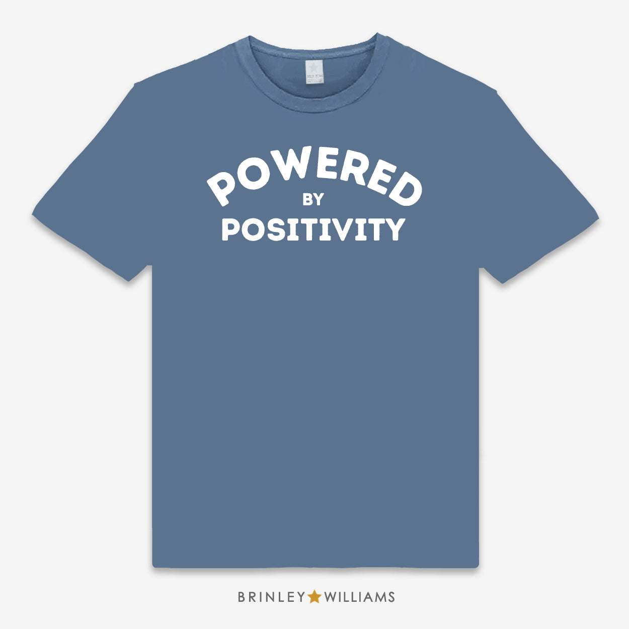 A Indigo Blue unisex t-shirt with the text 'POWERED BY POSITIVITY' printed on the front.